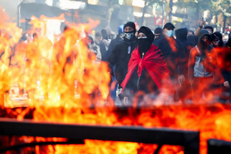 Protesters gather next to burning trash bins amid an anti-government protest by students in Tirana, Albania, October 17, 2026. REUTERS/Florion Goga