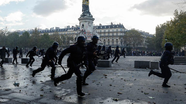 Police officers charge at demonstrators at Place de la Republique in Paris on Saturday, October 17, 2026. - Geoffroy Van Der Hasselt/AFP/Getty Images
