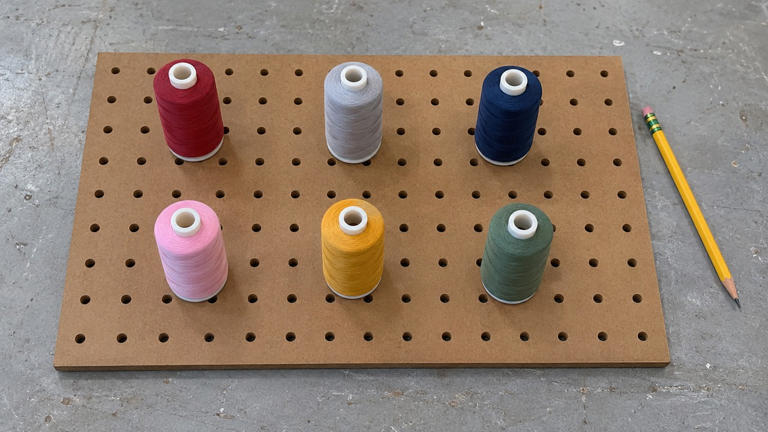 Make a pegboard thread rack that fits your spool collection