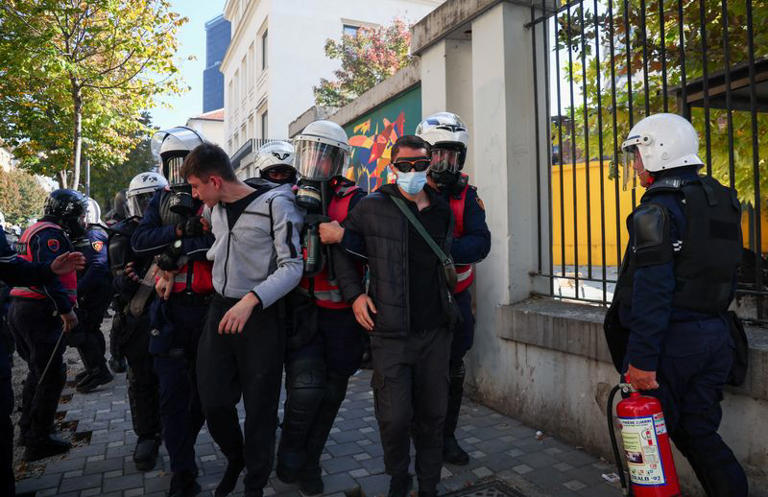 Police officers in riot gear detain people during an anti-government protest by students in Tirana, Albania, October 18, 2026. REUTERS/Florion Goga