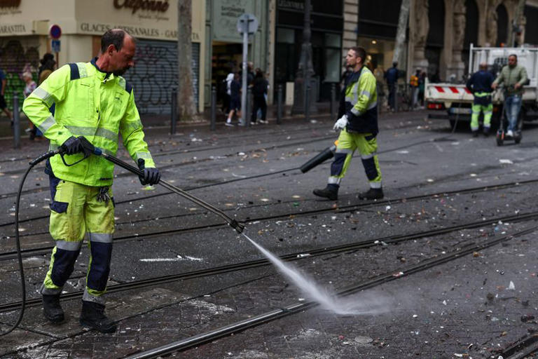City workers clean the street, the day after clashes during a national day of demonstrations against the cost of living and rising fuel prices, in Marseille, France, October 18, 2026. REUTERS/Manon Cruz