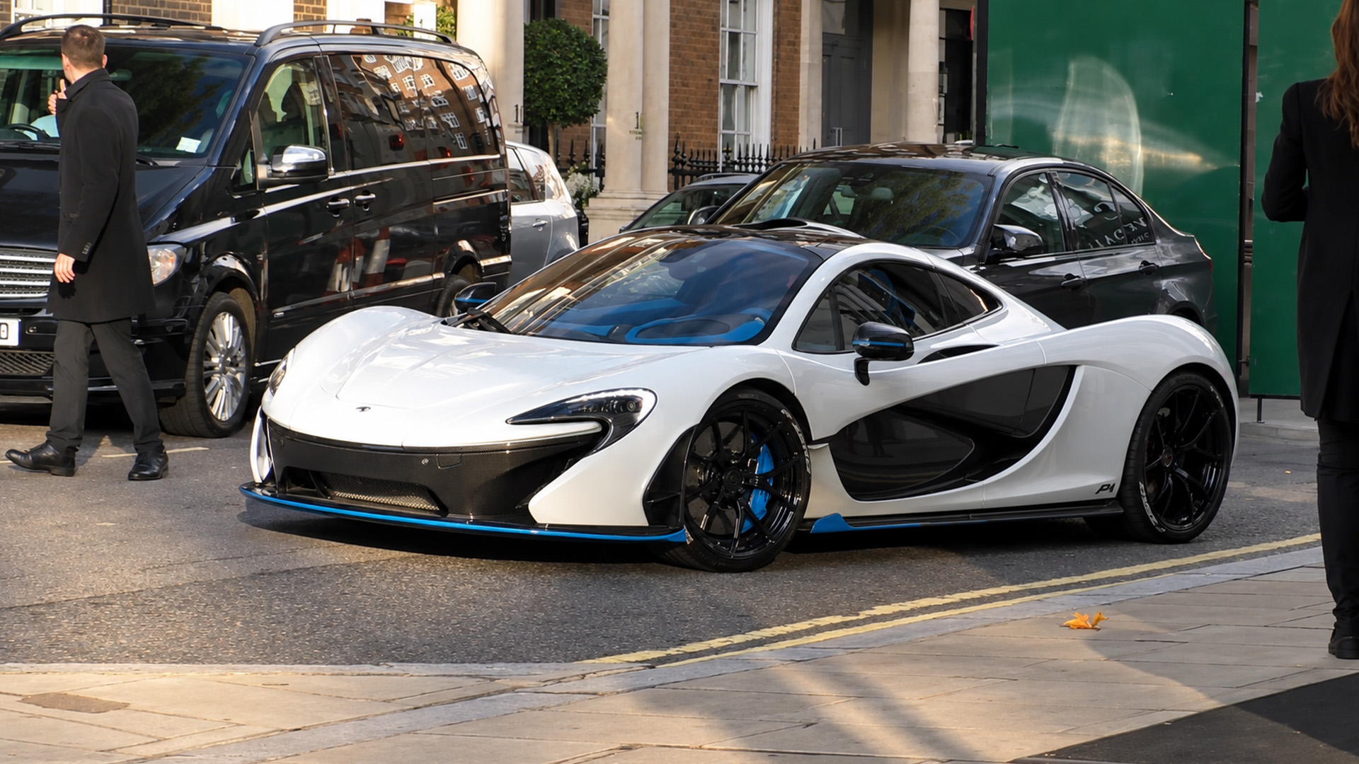 City life carries on around a millionaire’s $1.15M McLaren