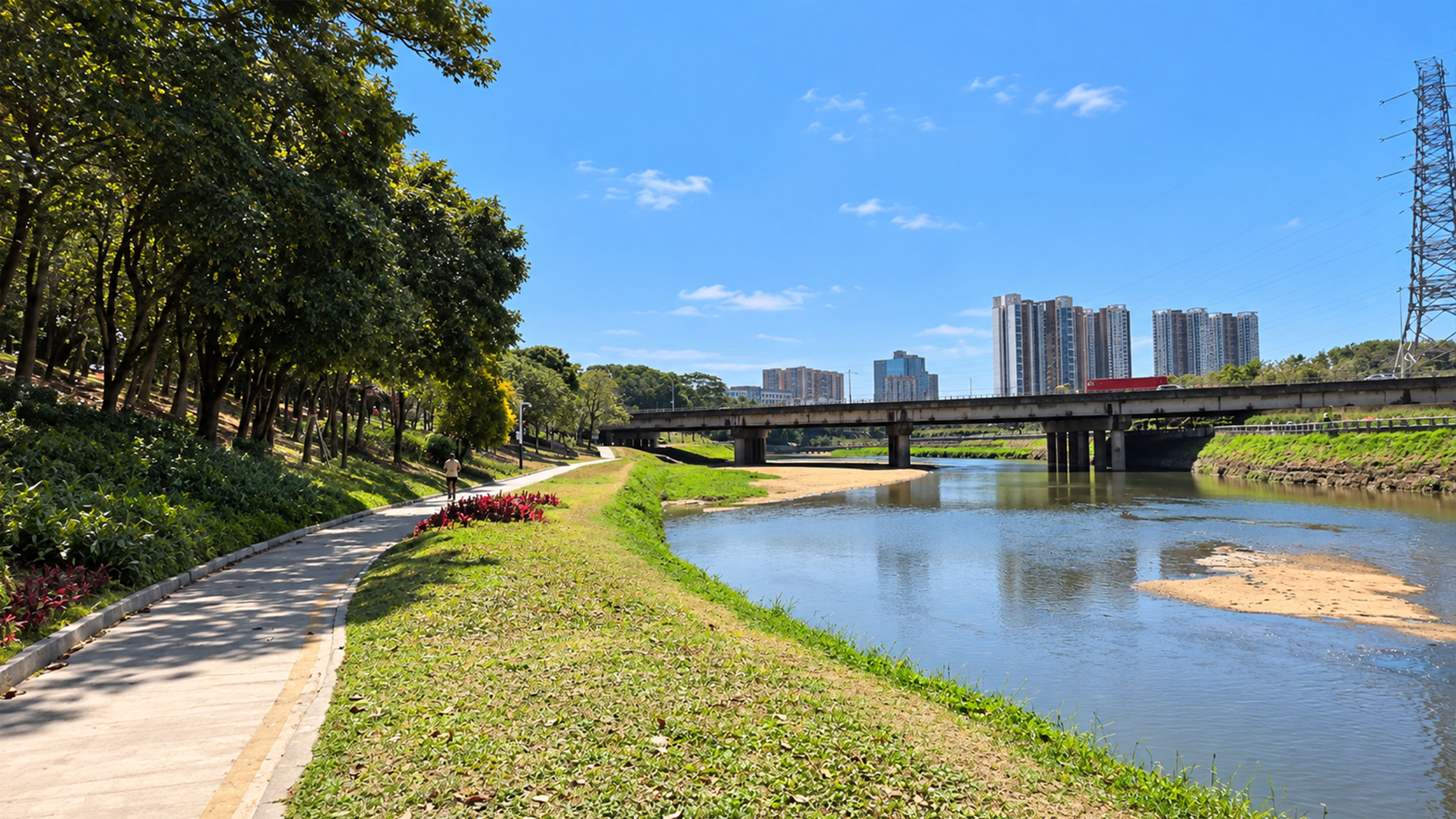Shaded riverside path runs beneath China’s apartment towers