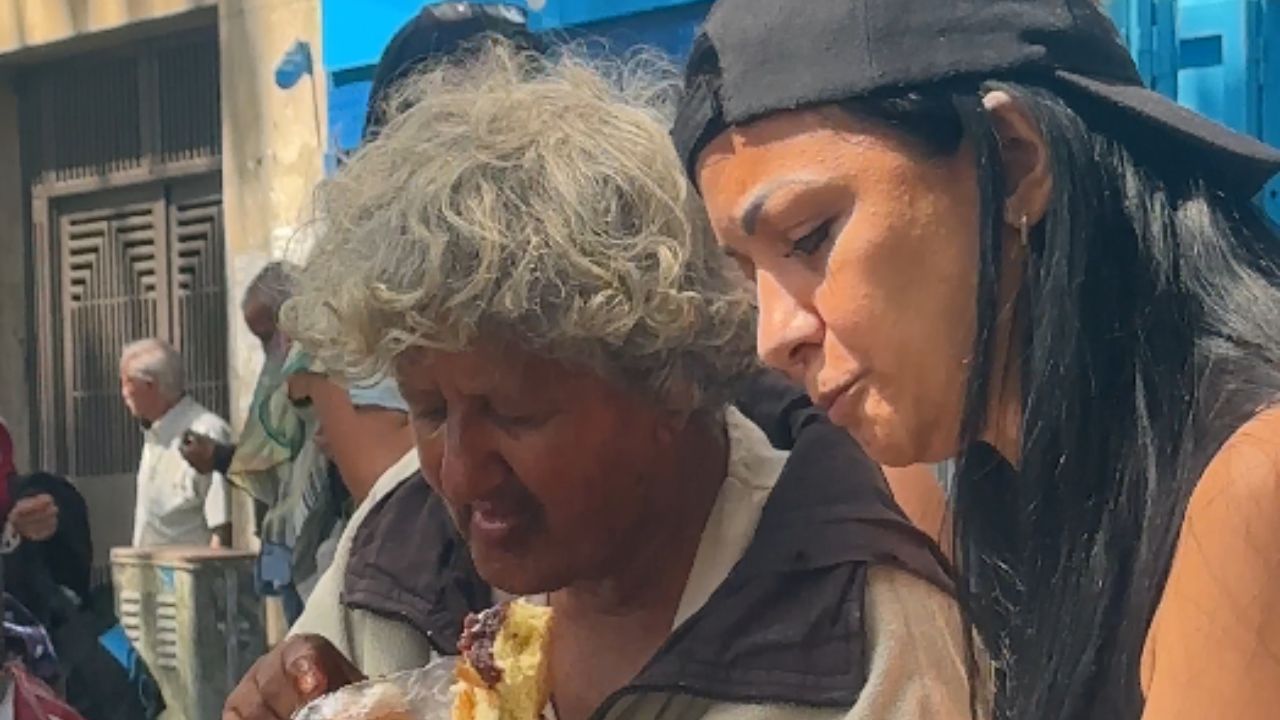Compassionate woman makes a homeless woman's day with her kind gesture