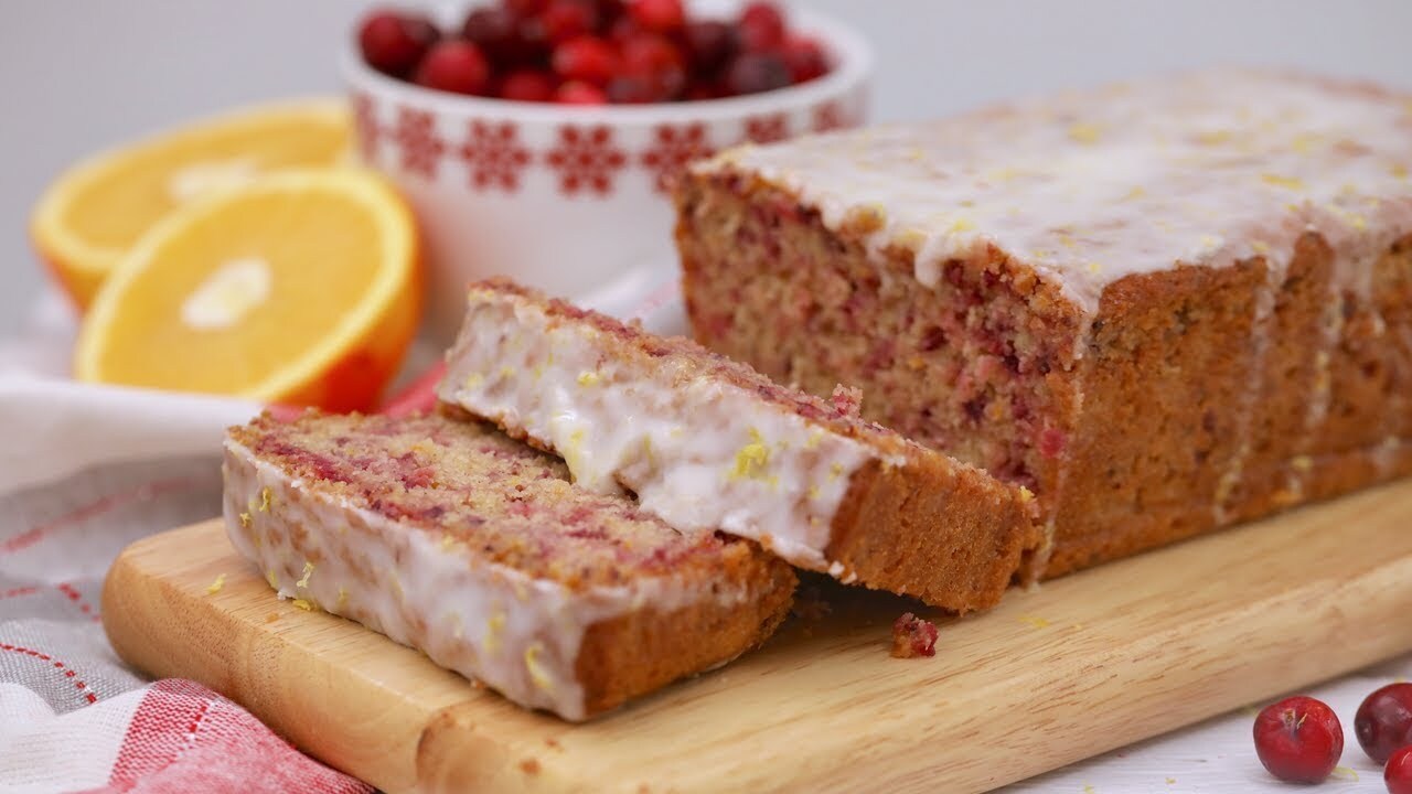 Cranberry orange cake topped with a zesty lemon glaze