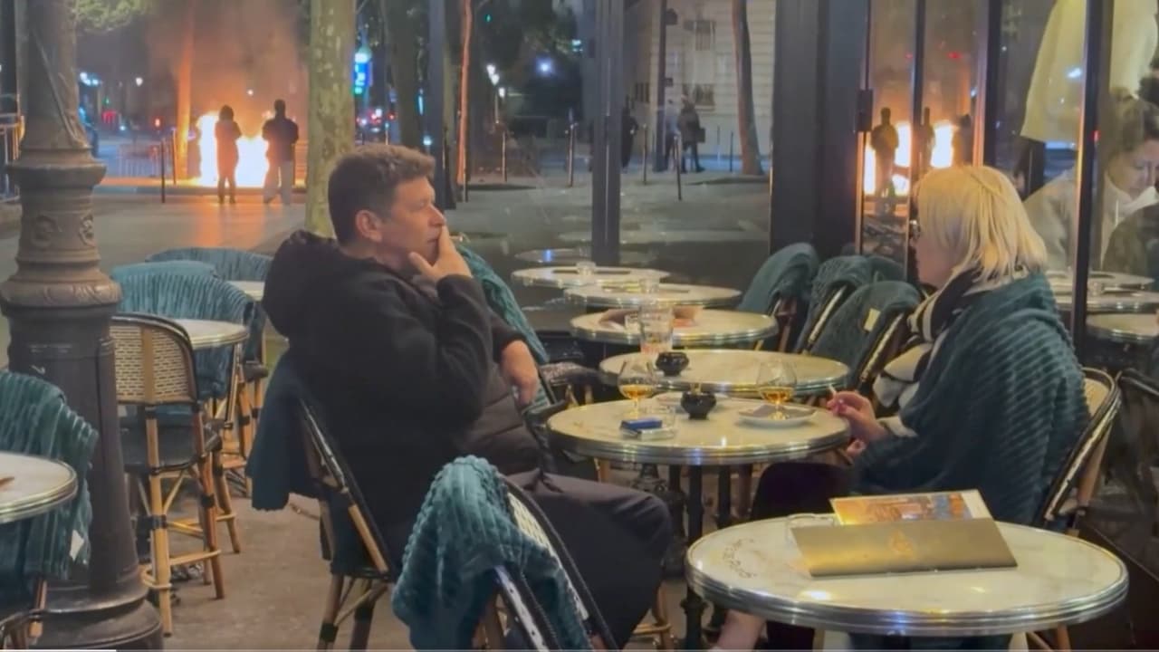 France couple smokes, sips wine unfazed by flames in background during ...