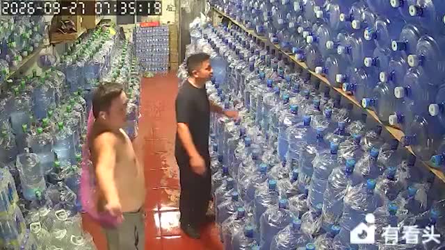 Workers trigger towering stack of water bottles to collapse in China