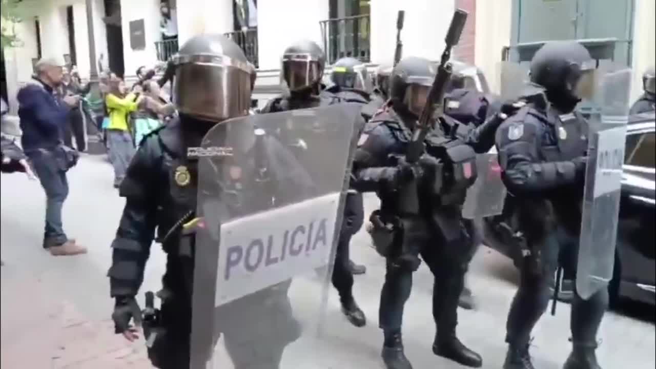 Riot police fire rubber pellets as they charge striking teachers in Madrid