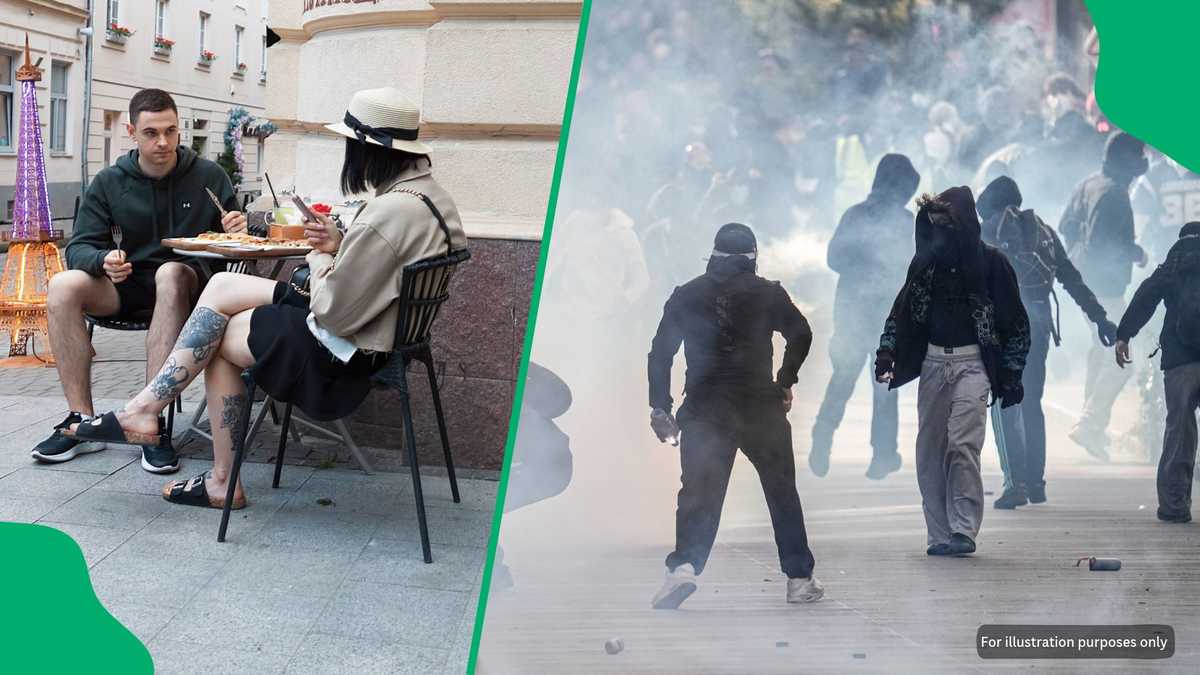 Paris couple behaviour near Arc de Triomphe as riots rage behind them ...