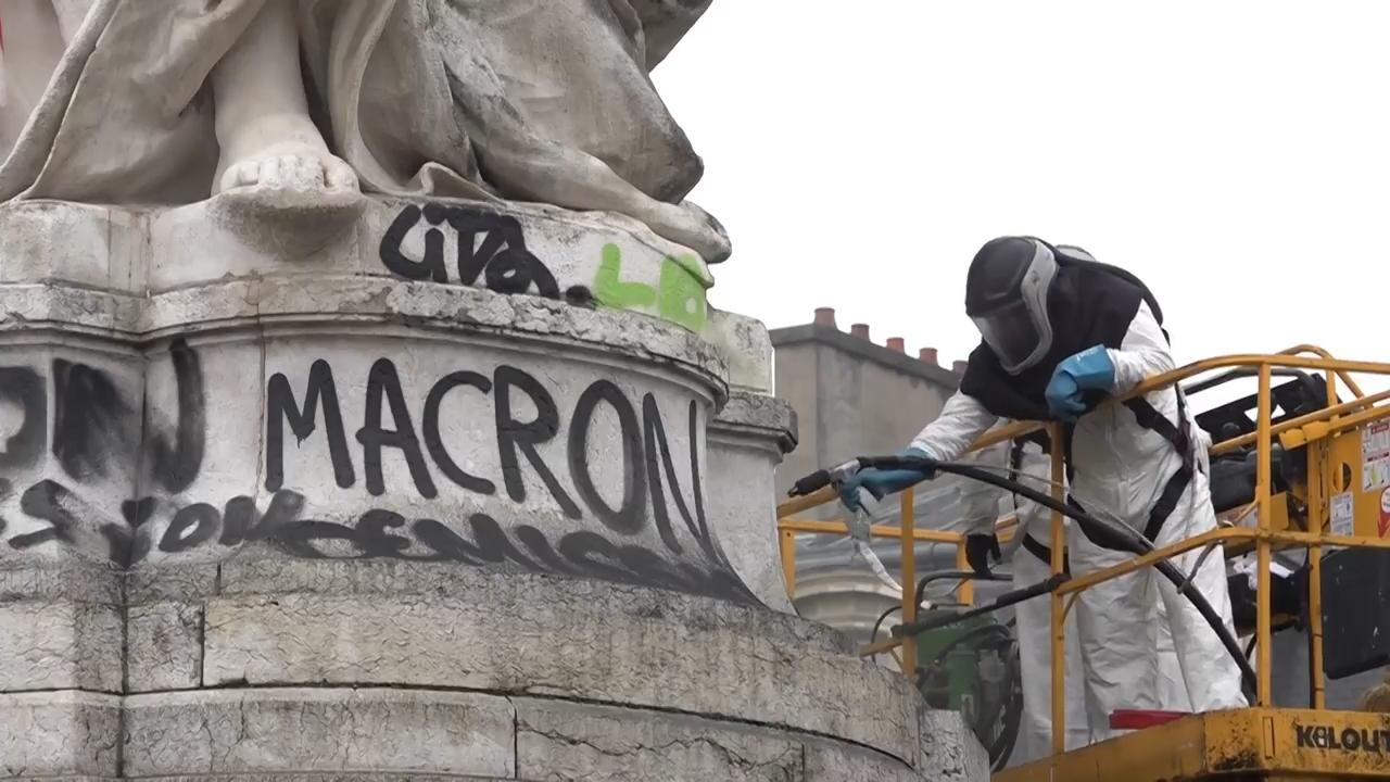 Shop owners and volunteers clean up after riots in Paris