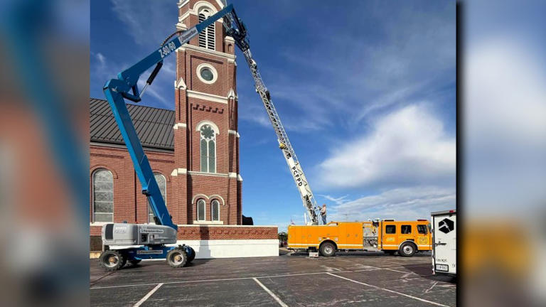 Firefighters rescue painter stranded atop church tower