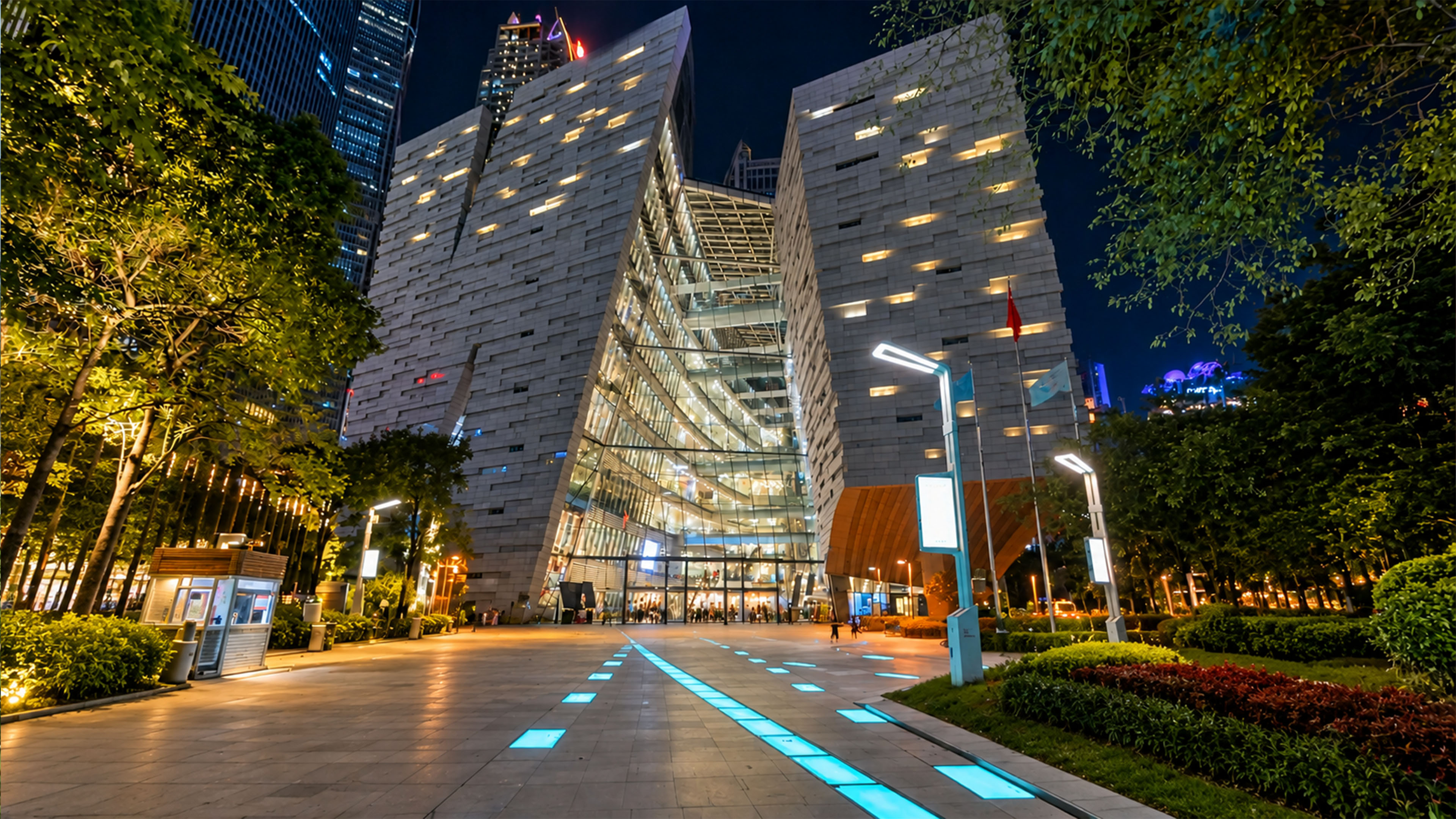 Two massive buildings frame a glass atrium in Guangzhou