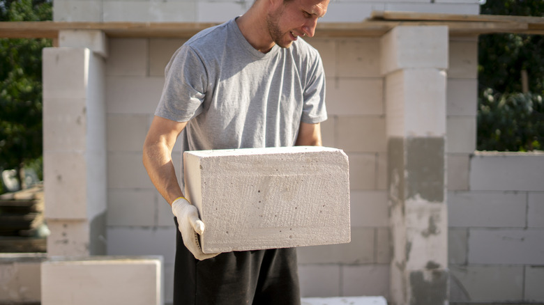 Man uses concrete blocks as a savvy alternative to an end table