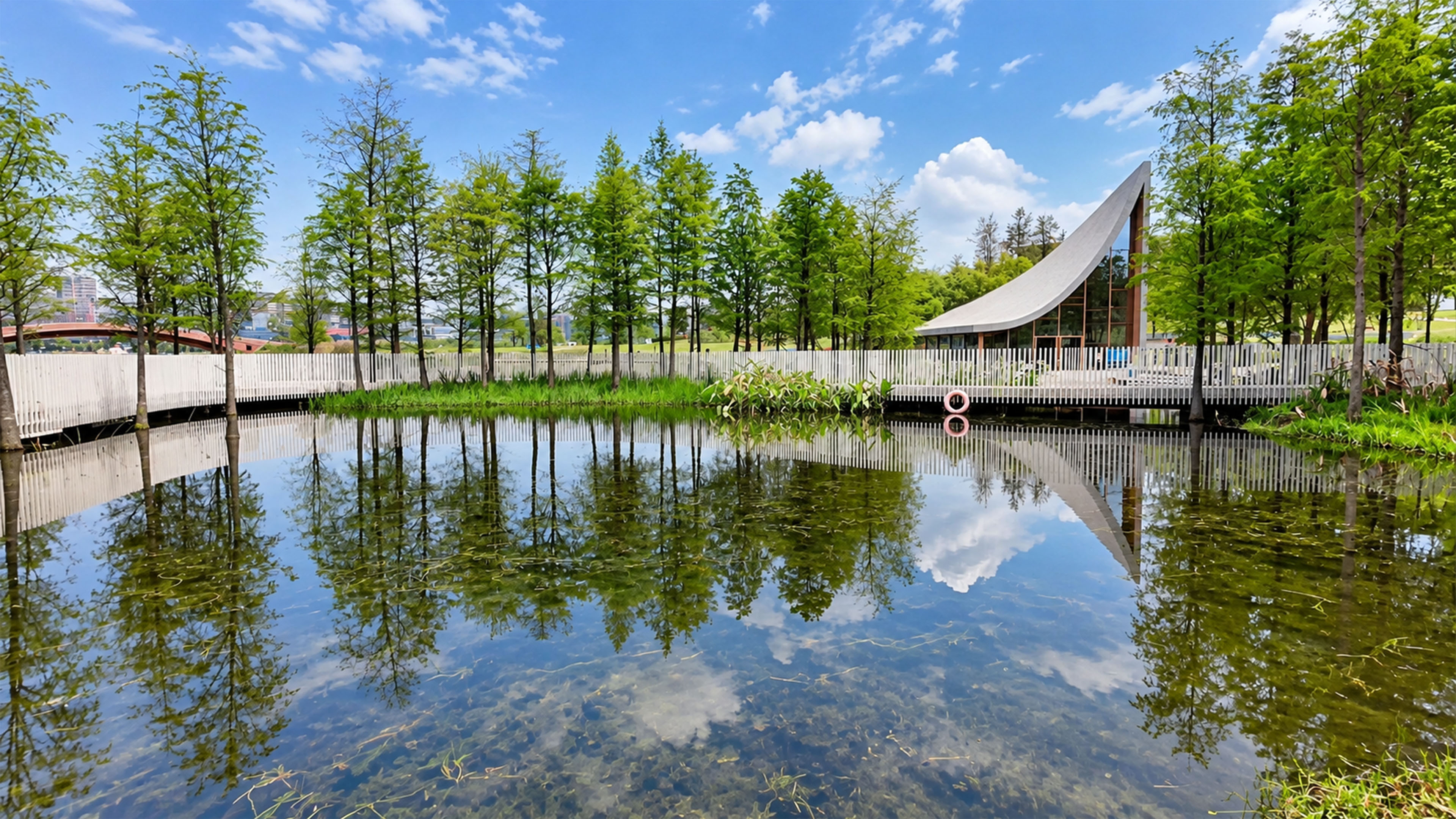 Curved modern pavilion reflects across this China pond