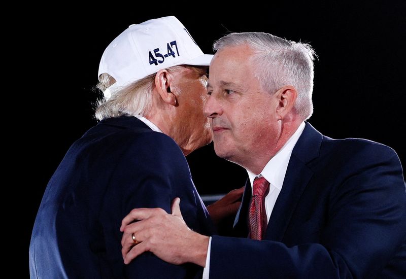 US President Donald Trump interacts with Michael Whatley, Republican candidate for North Carolina's US Senate seat, during a campaign rally at Pitt-Greenville Airport in Greenville, North Carolina, US, October 20, 2026. REUTERS/Evan Vucci