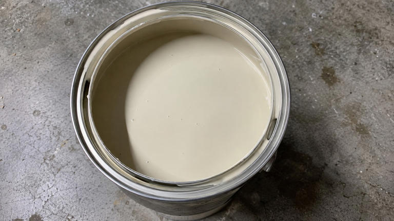 Why do some paint cans have small holes in the rim?