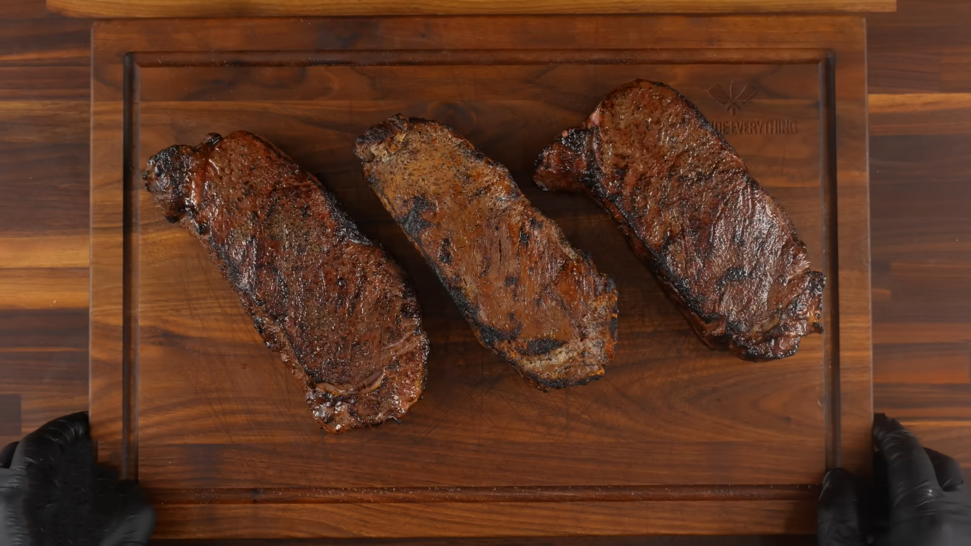 Cooking steaks over an open fire inside a thick salt crust