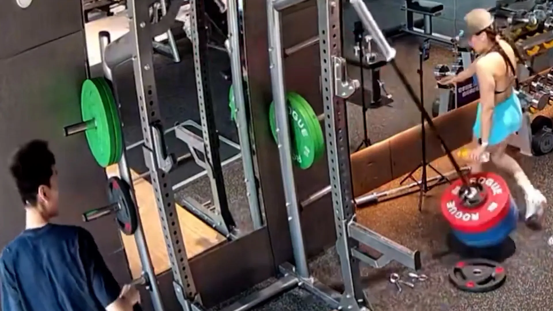 Bungling gymgoer nearly drops barbell on woman filming selfie video