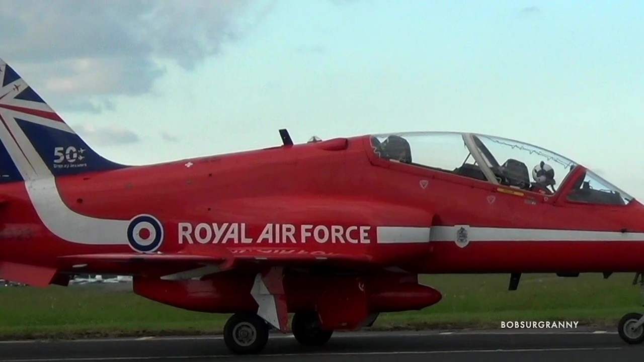 The Red Arrows make a close formation pass - nine jets moving as one