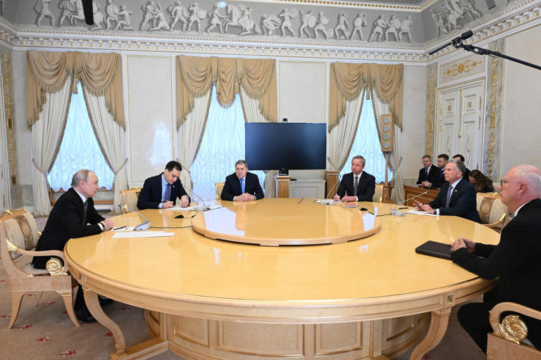 Kristina Solovyova/POOL/AFP via Getty Images - PHOTO: Russia's President Vladimir Putin, Kremlin foreign policy aide Yuri Ushakov and presidential envoy Kirill Dmitriev attend a meeting with U.S. special envoy Steve Witkoff in St. Petersburg on Oct. 21, 2026.
