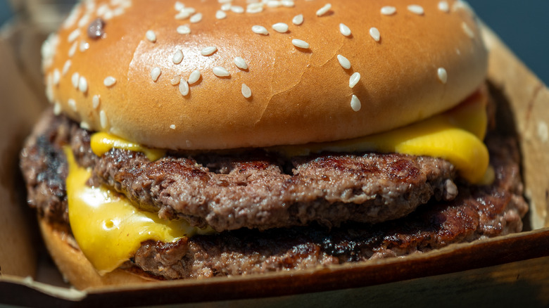 How does McDonald's season its iconic beef patties?