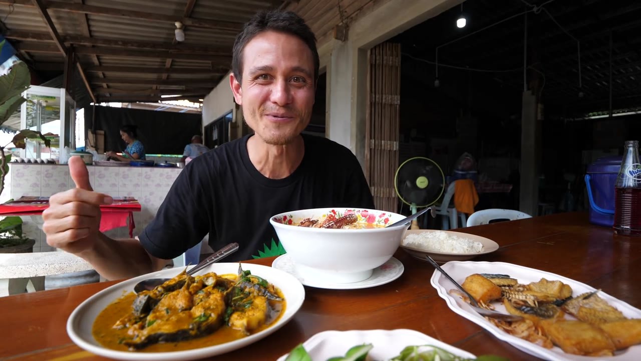 Trying giant shrimp tom yum and spicy fish curry at a small Thai restaurant