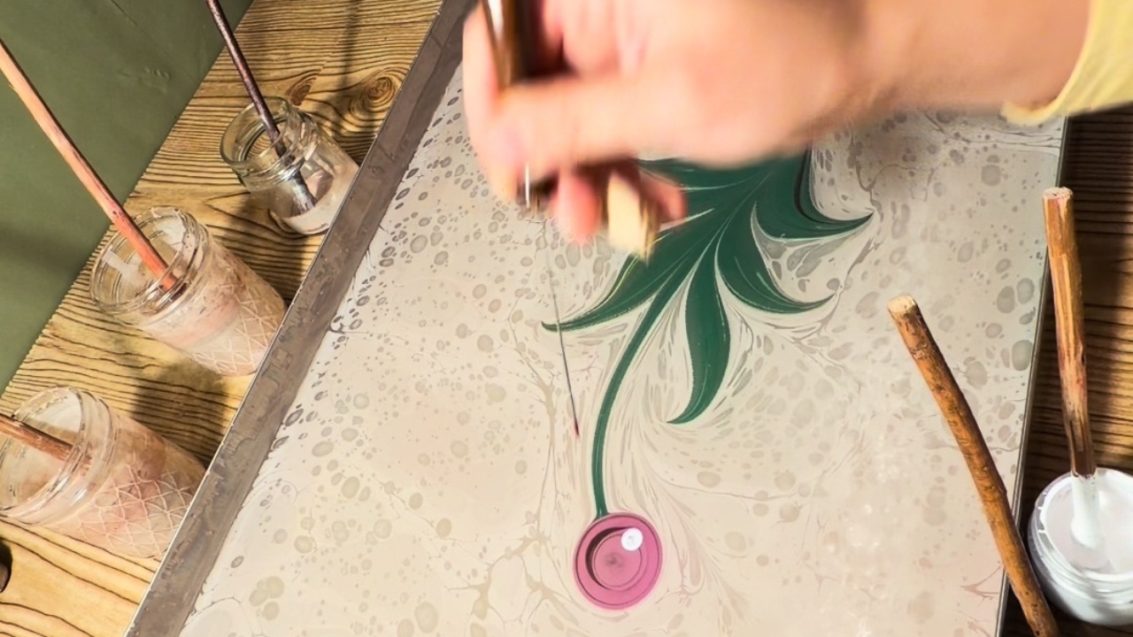 Artist creates pink flower using traditional Turkish ebru art