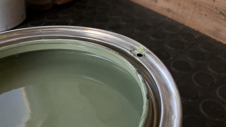 Why do some paint cans have small holes in the rim?