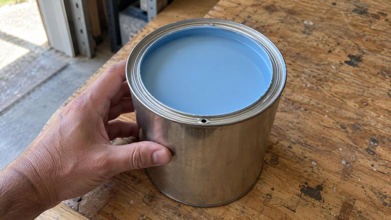 Why do some paint cans have small holes in the rim?