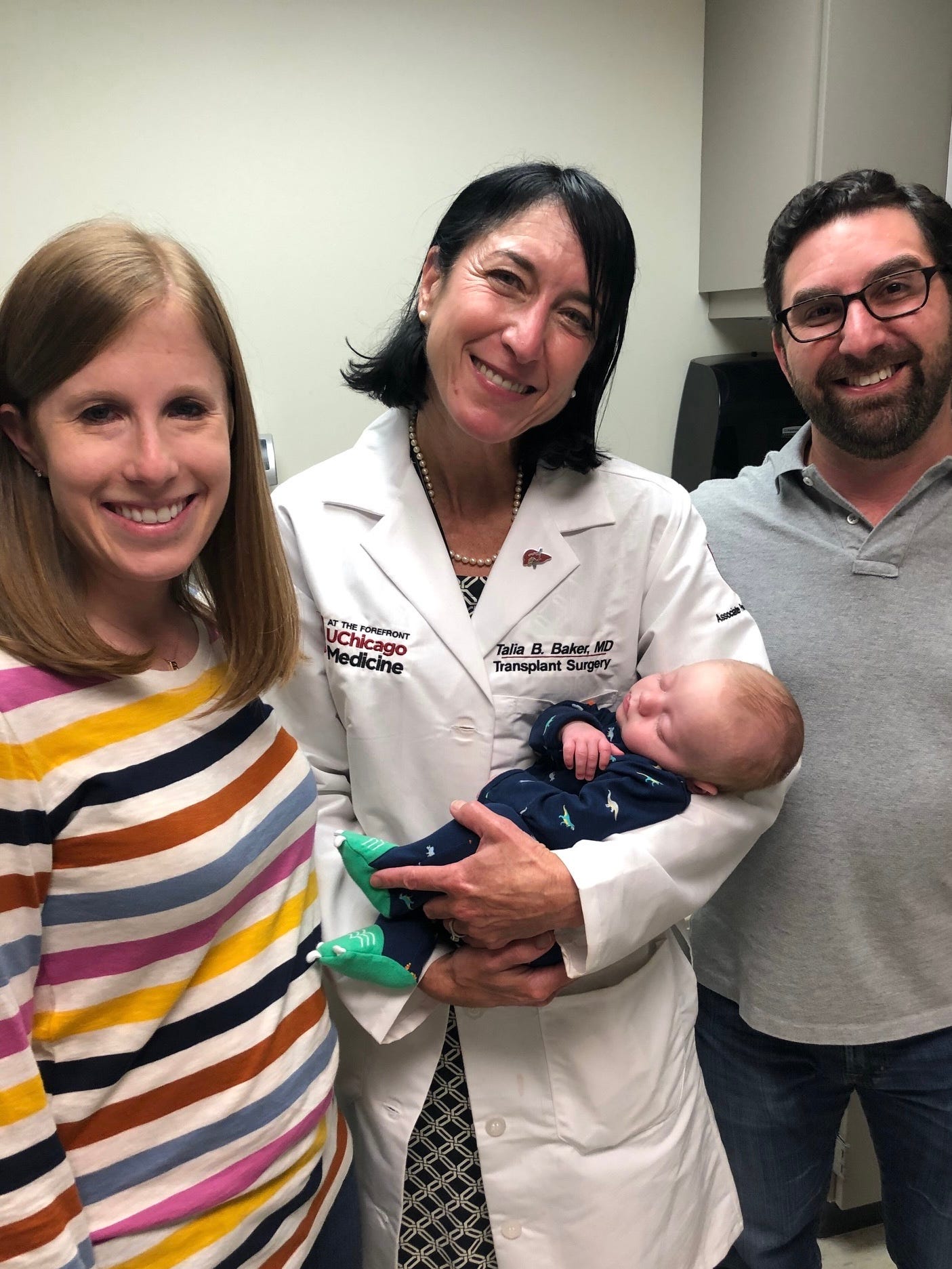 Dr. Talia Baker (center) meets Baker Leon for the first time with his parents, Nicole Leon and Larry Leon.