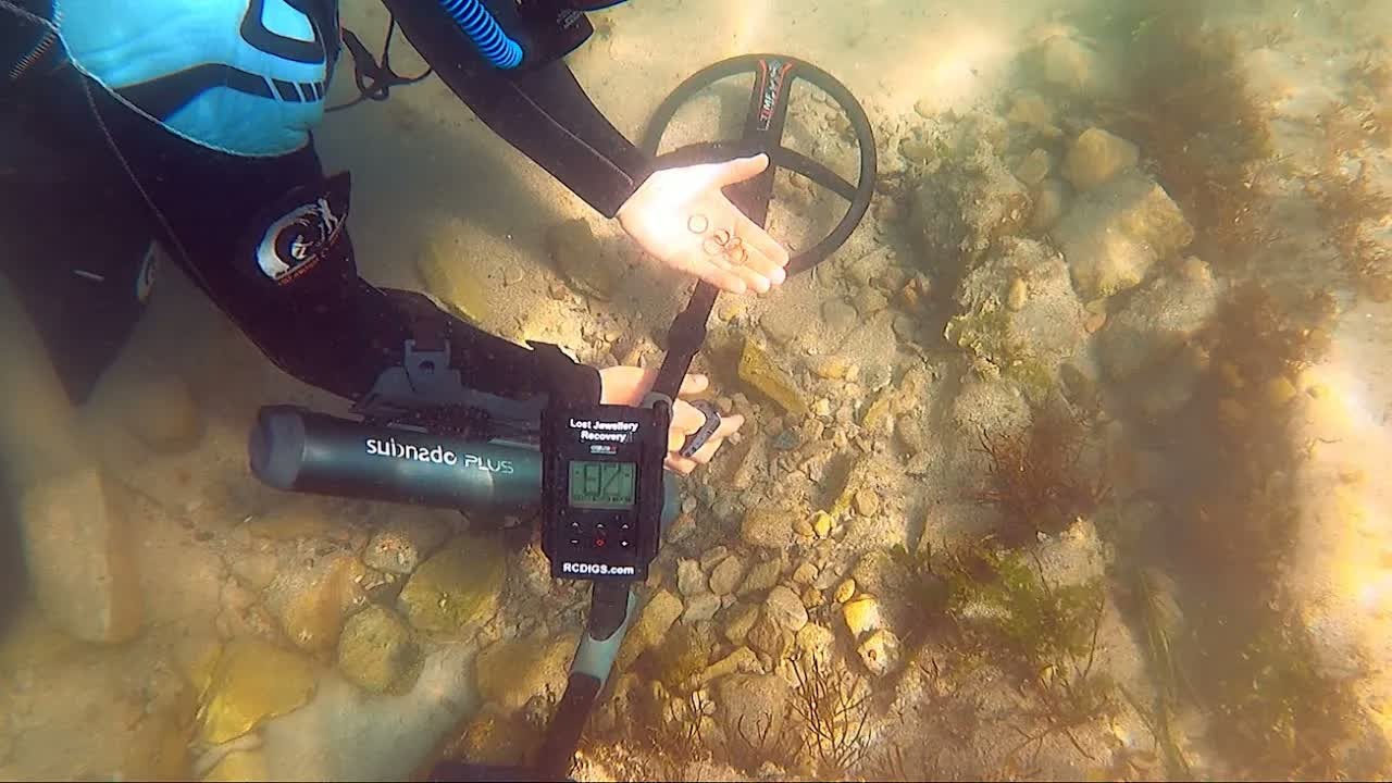 Michael Oliver finds a gold ring and earring in an old swim bay