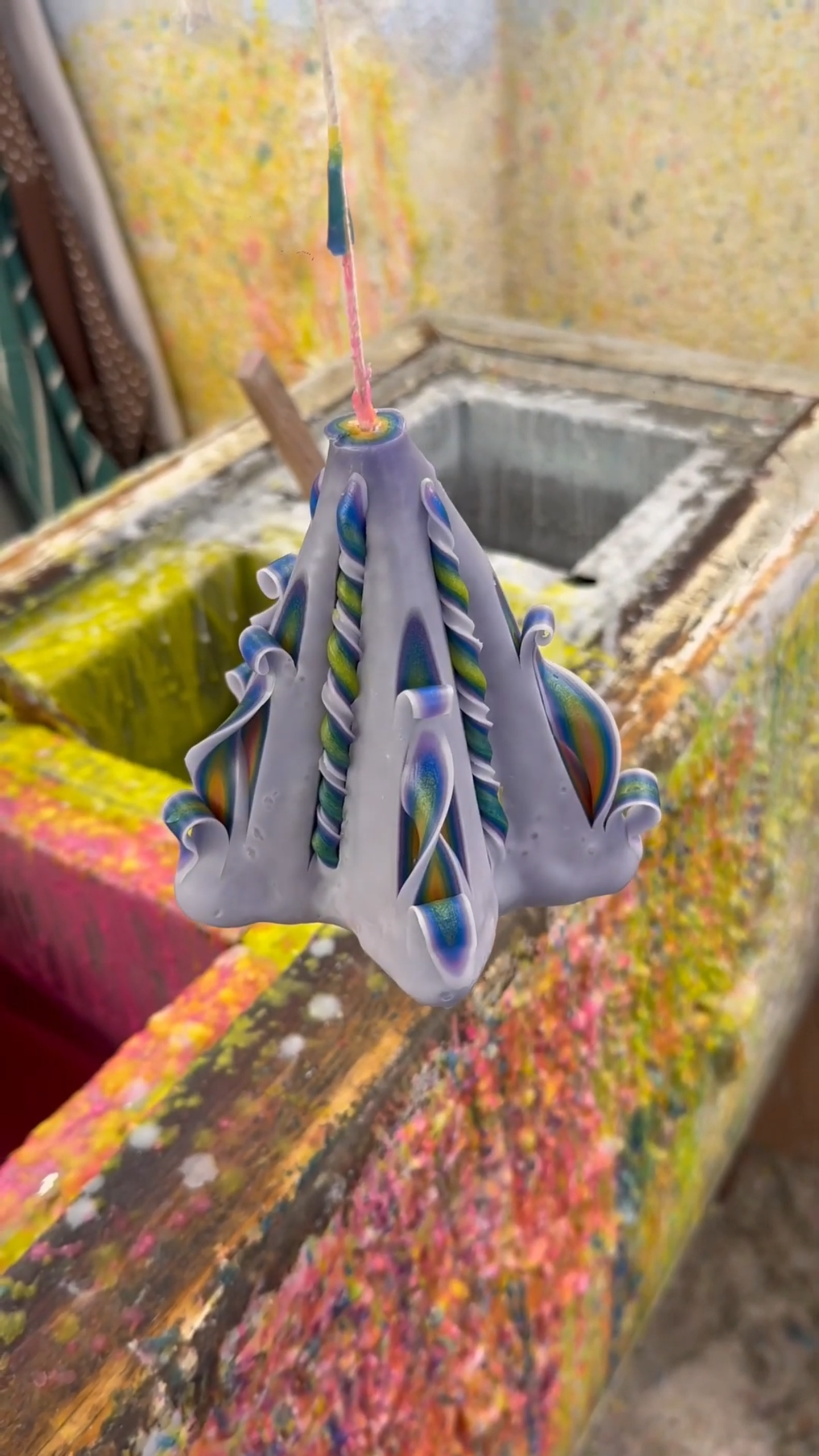 Creative rainbow candle wax art with colorful designs