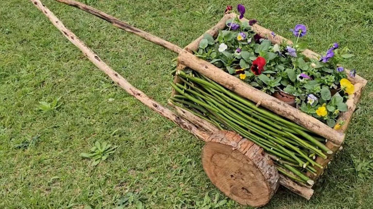 They made a charming wheelbarrow planter from fallen branches
