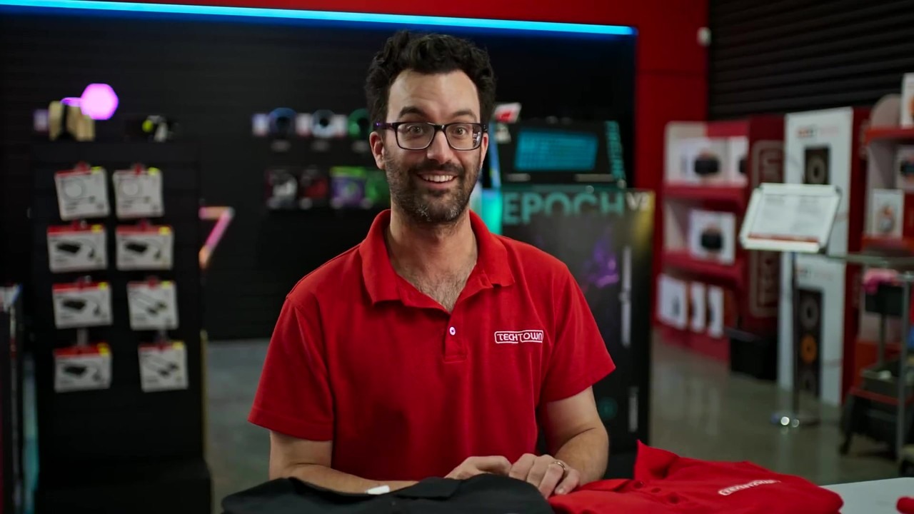 Rowan has Adam run a red shirt peasant merch stall for TechTown fans