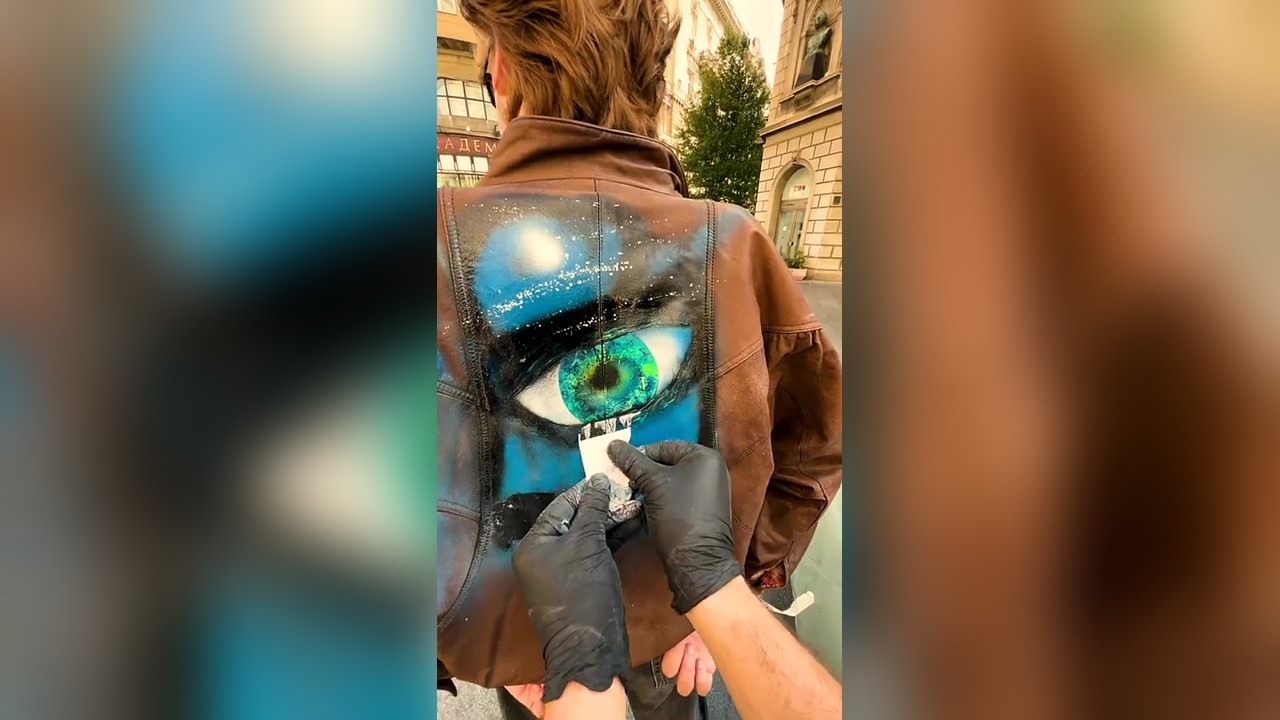 Spray painting a stranger's leather jacket