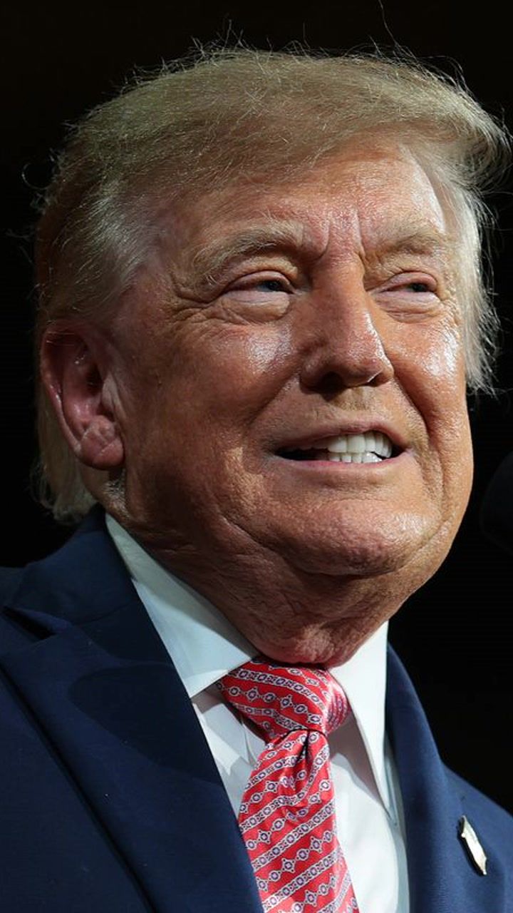 MAGA supporter in 'America First' cap shakes head at Trump's wild claims