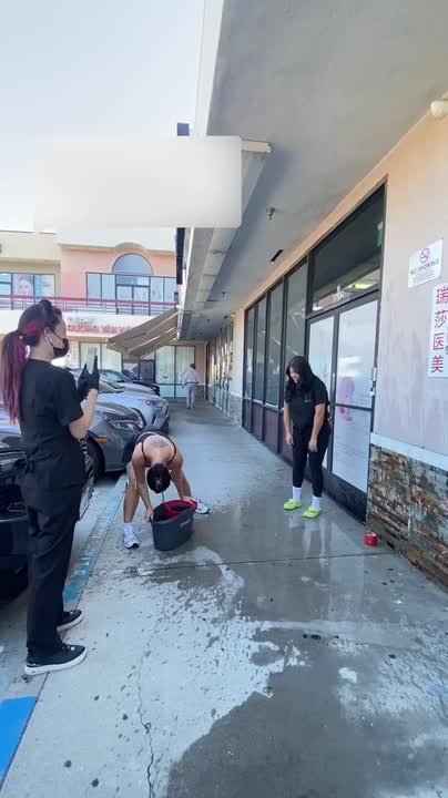 Person struggles to splash friend while filming water prank