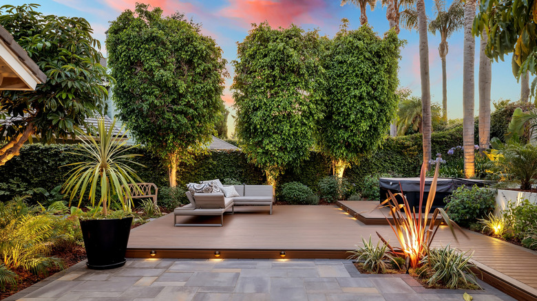 She used simple, affordable materials to build a floating backyard deck ...