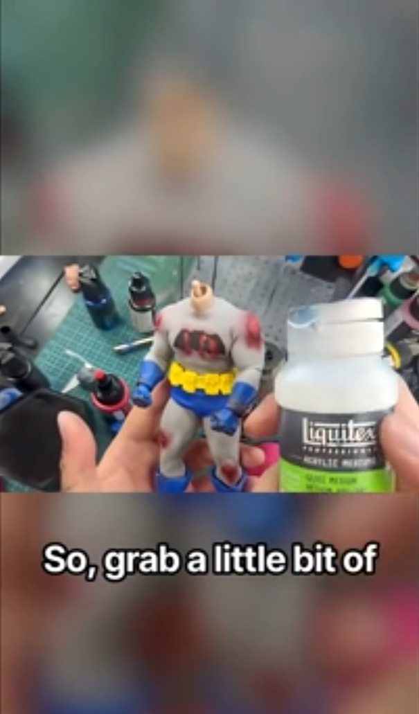 Adding realistic battle details to Batman and Superman figures