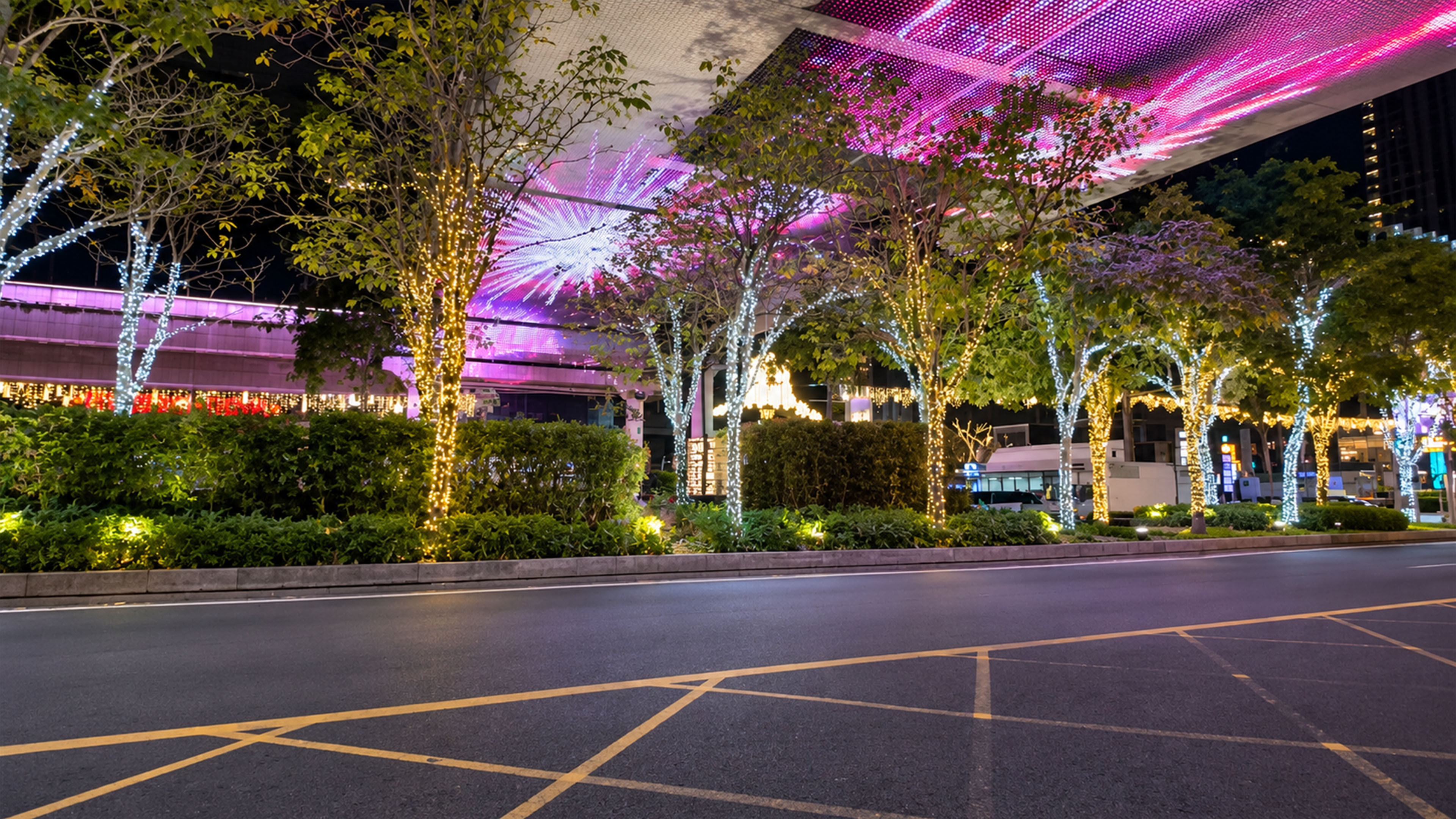 A giant pink LED canopy glows above Shenzhen's city street