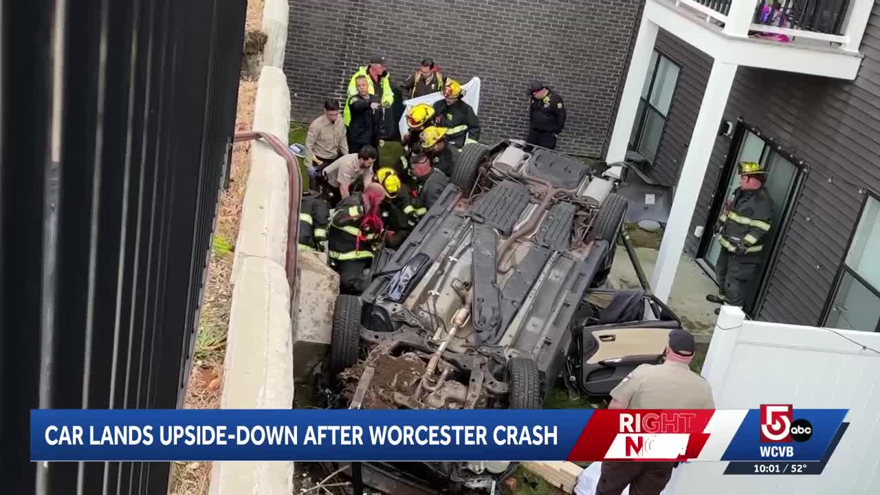 Driver injured after car crashes through fence, lands on roof of ...