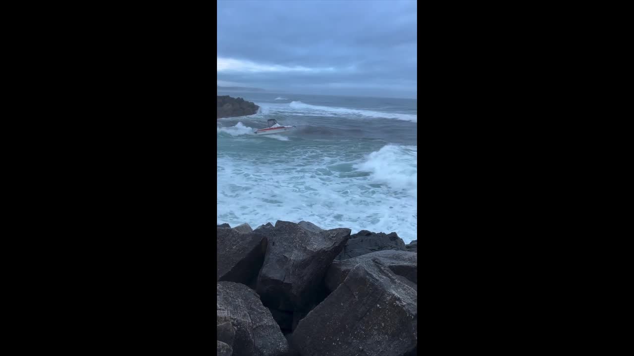 Waves batter leisure boat before it sinks off the coast of Australia