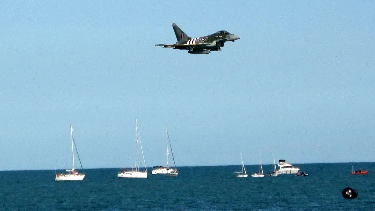 A Typhoon fighter jet pulls into a steep climb during the 'Turbo' display