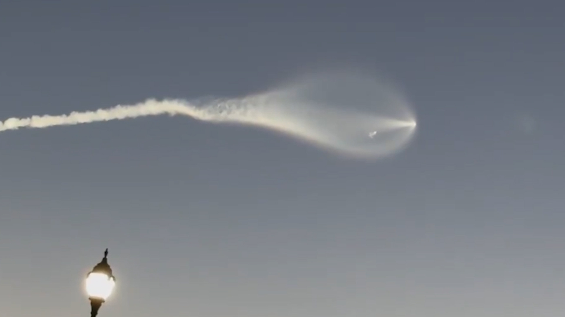 SpaceX launch leaves glowing jellyfish-shaped plume in Florida dawn sky
