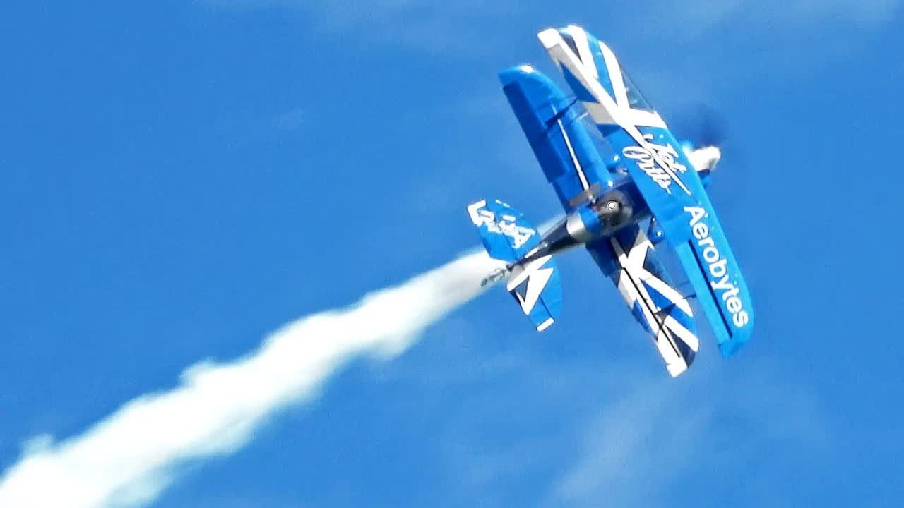 Pitts S-2 biplane pulls into a vertical climb - the pilot rolls it ...