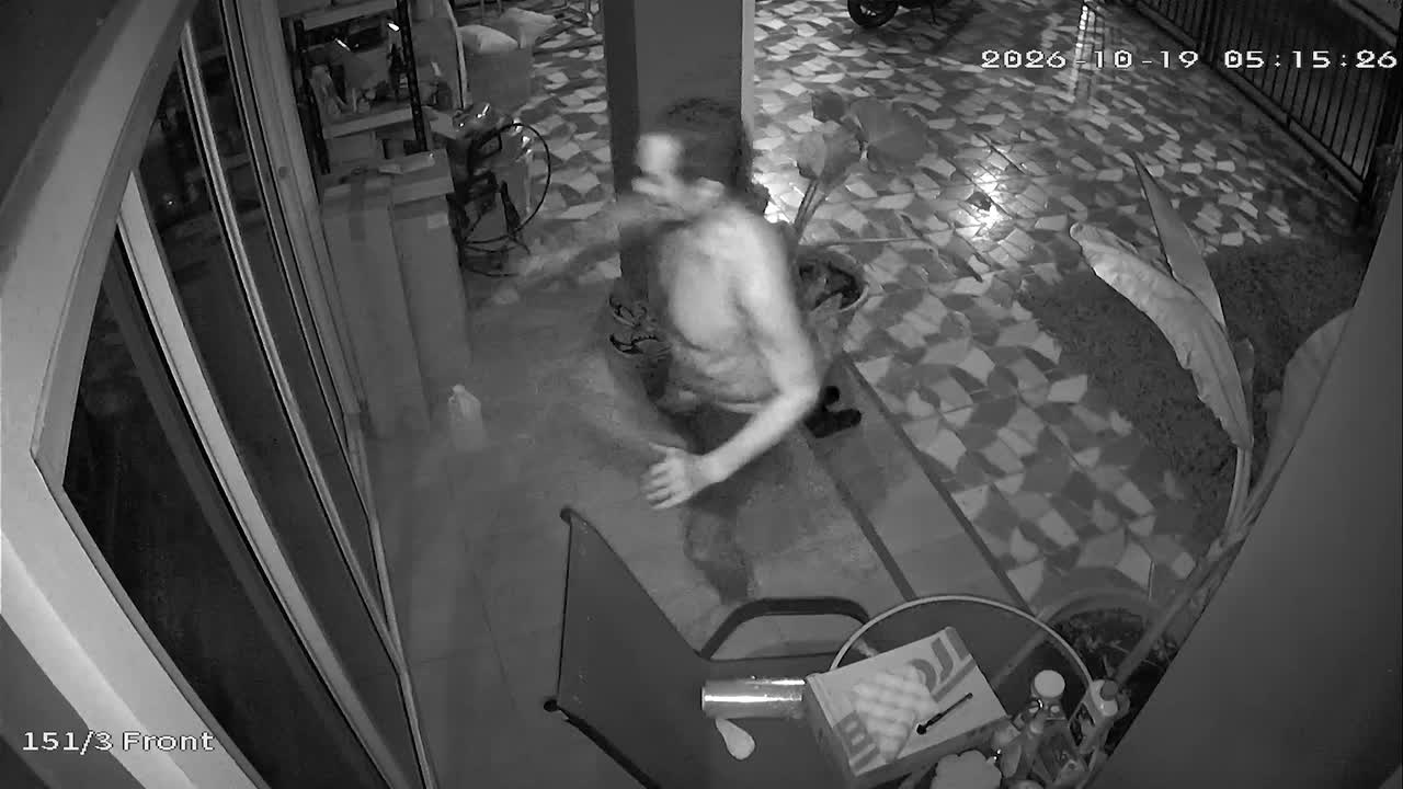 Crazed neighbour caught on CCTV smashing patio door