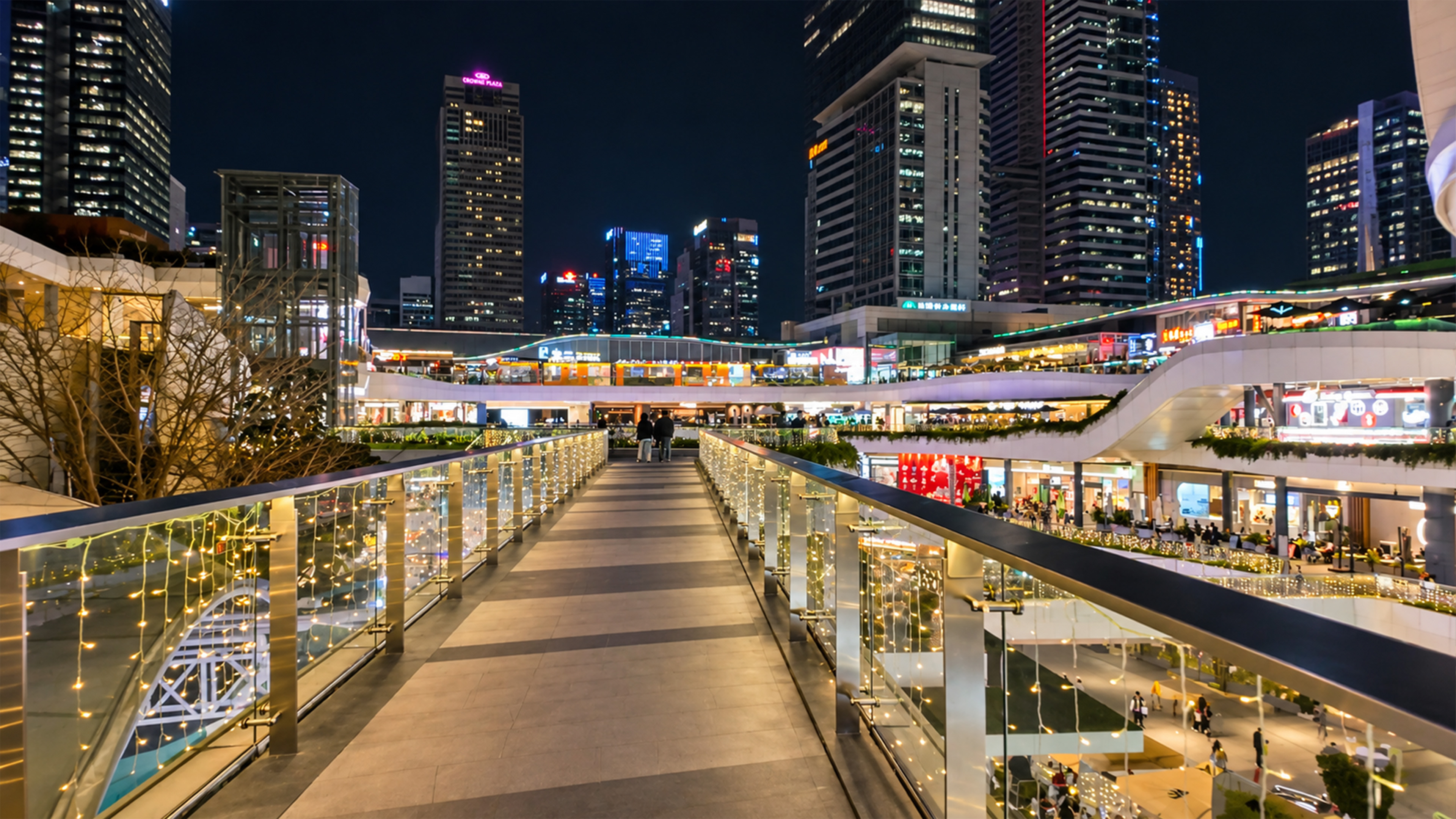 Glass walkway crosses above Shenzhen's multi level shopping plaza
