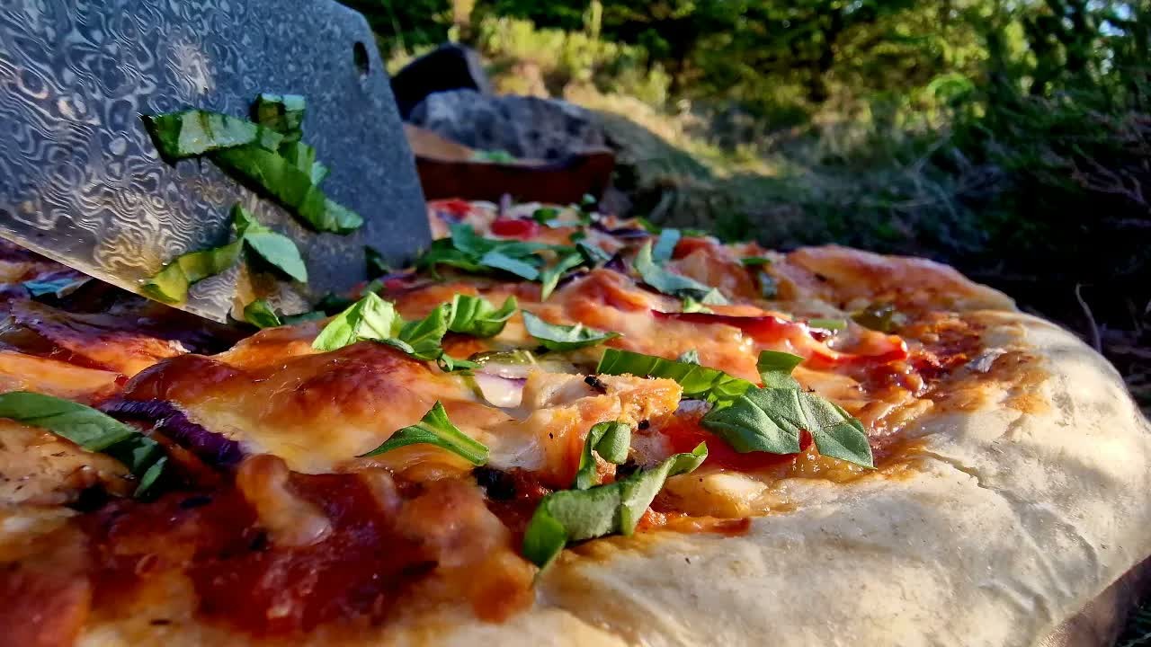 Chicken, bacon and chilli pizza cooked over an open fire