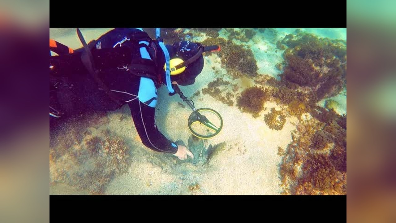 A diver finds cash, gold and diamonds while searching underwater