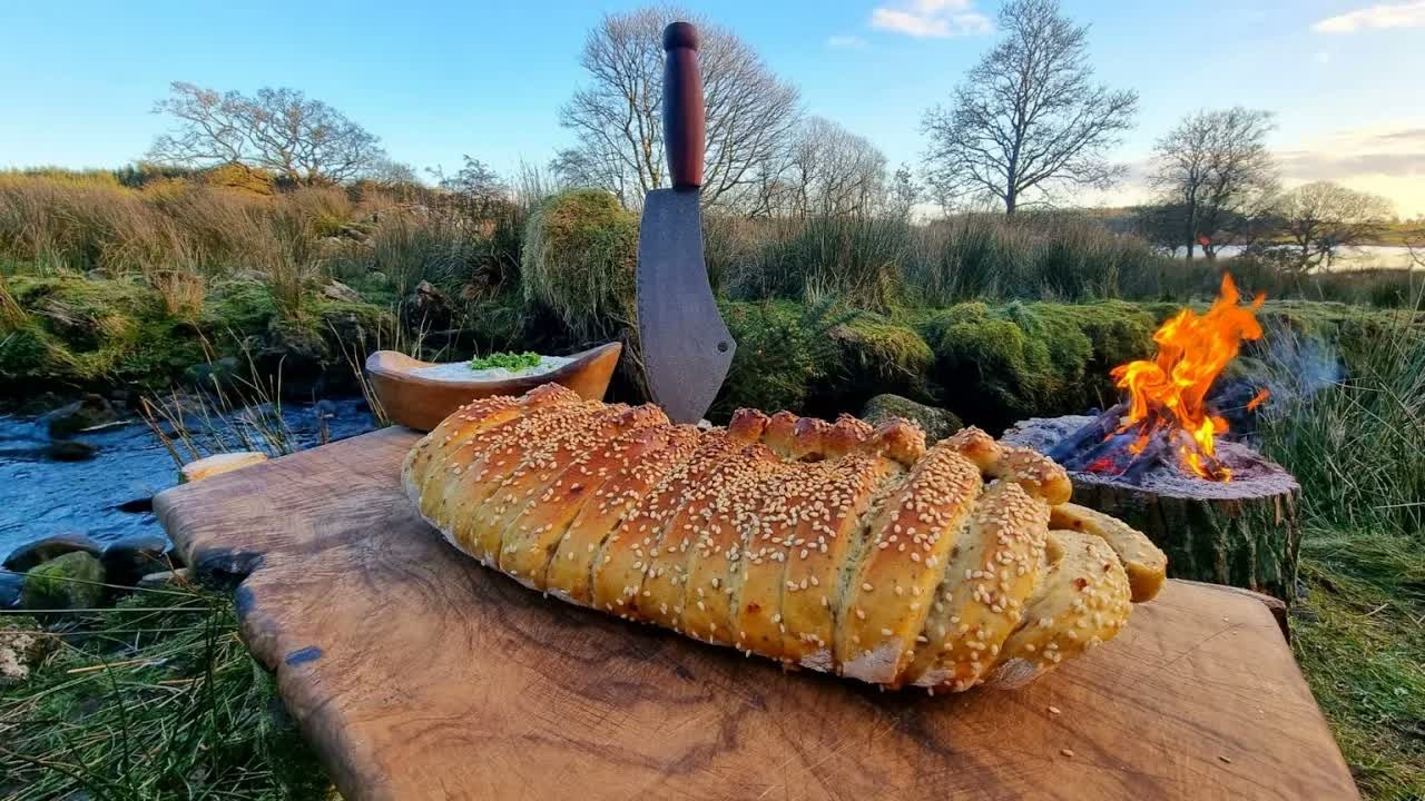 Stuffed bread cooks outdoors in a bushcraft-style ASMR session